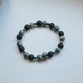 Skull bracelet with lava and green beads